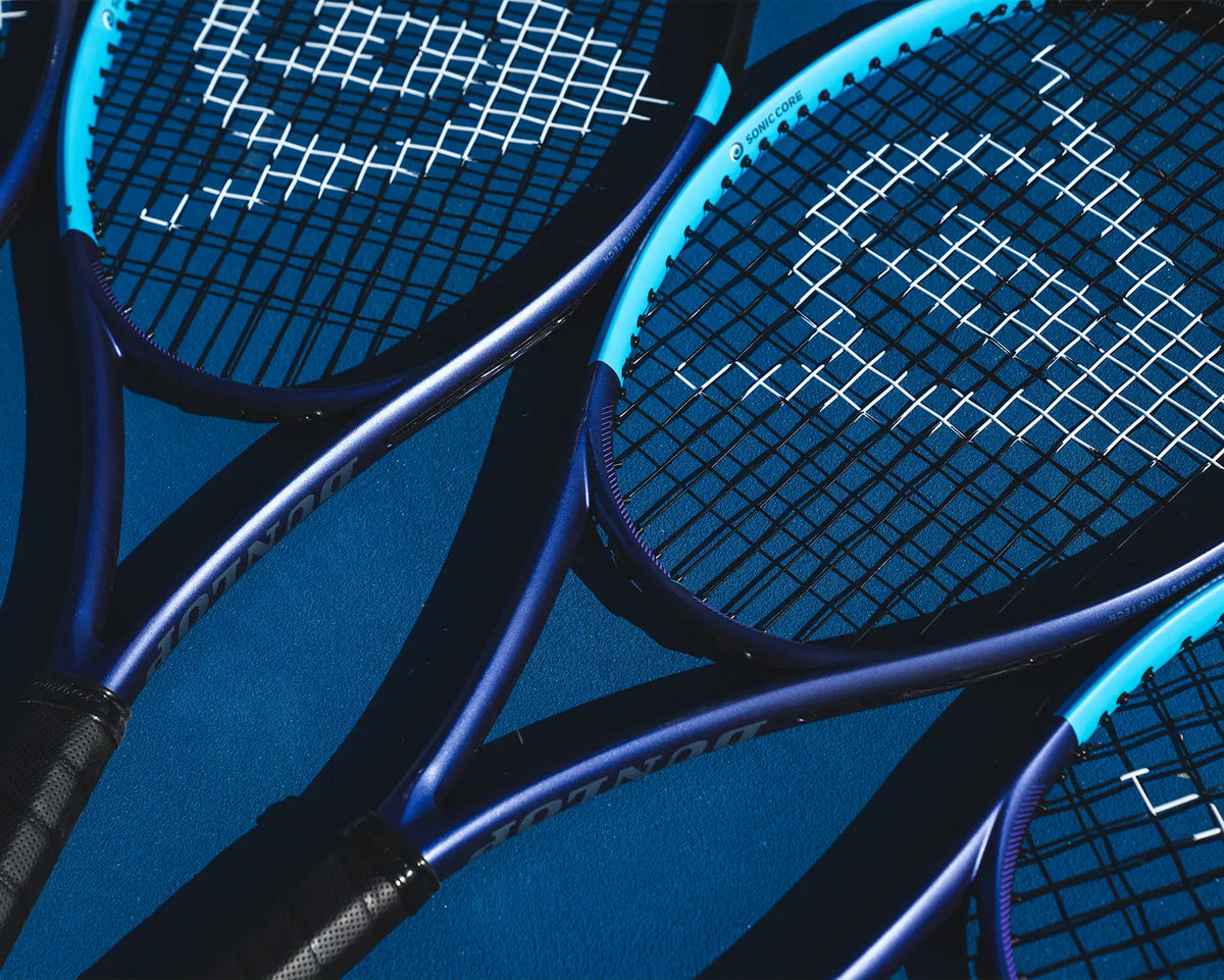 Close-up of two blue tennis rackets with a blue background