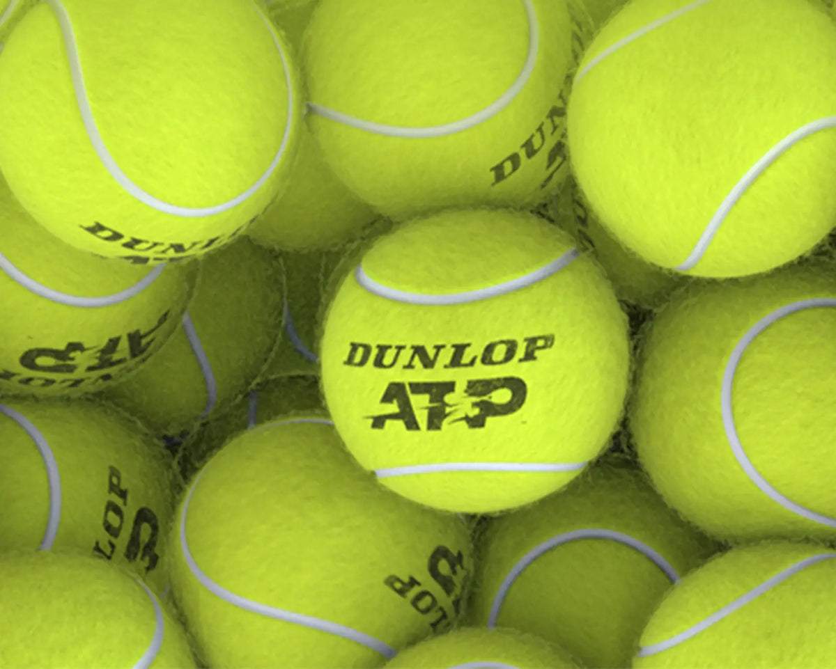 A close up shot of multiple Dunlop ATP tennis balls.